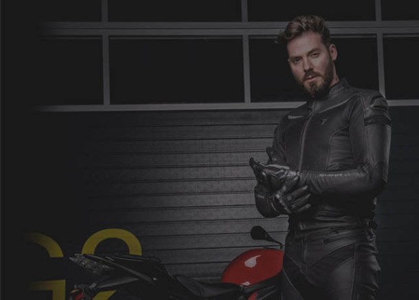 Motorcyclist wearing Xtron riding jacket and helmet
